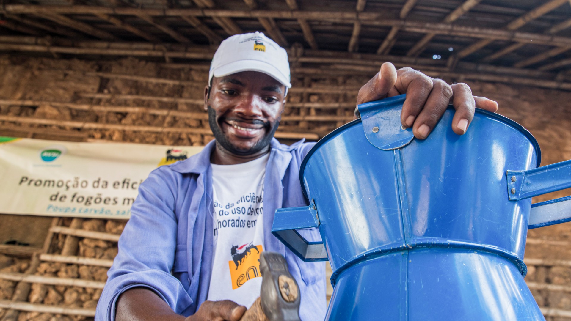 African man works on creating a cooking stove