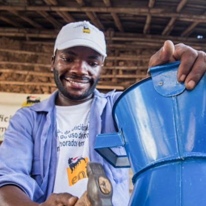 African man works on creating a cooking stove