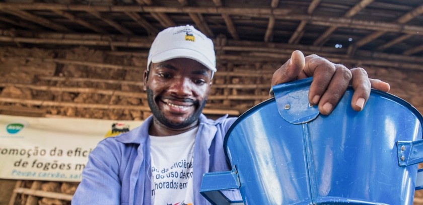 Mozambican craftsman works to create a stove for cooking 