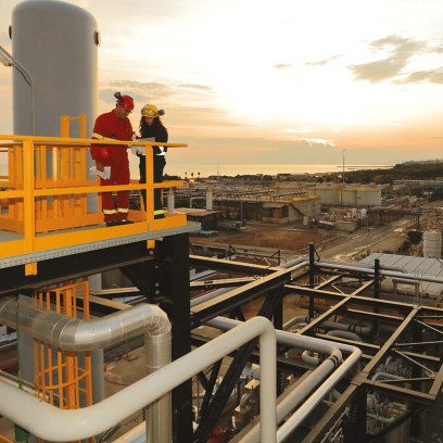 Workers over the Gela plant at sunset