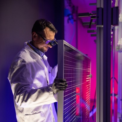Scientist fixes solar panel in laboratory