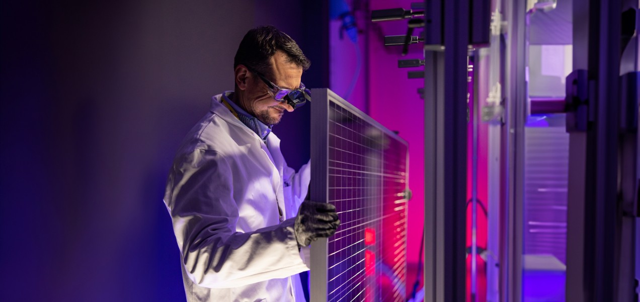 Scientist fixes solar panel in laboratory