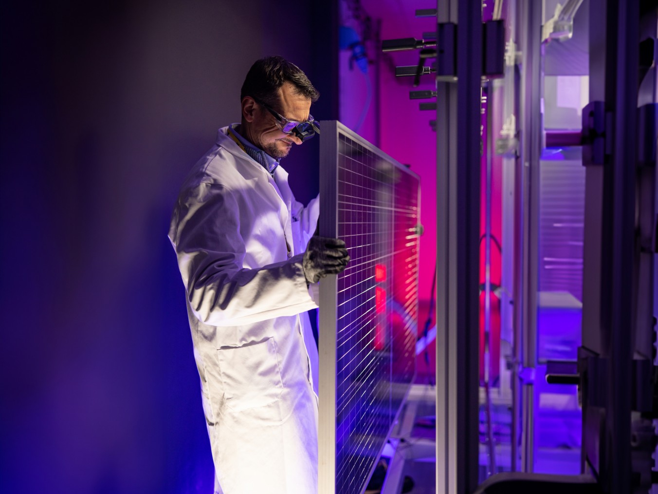 Scientist fixes solar panel in laboratory