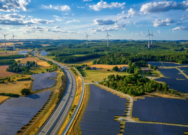 Natural landscape with solar panel and wind power plant road