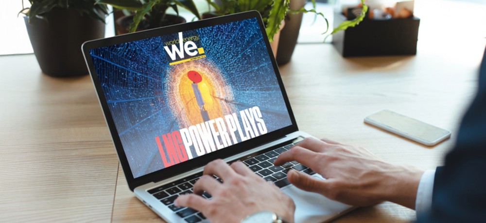 Person on laptop viewing digital magazine "we." with futuristic cover.