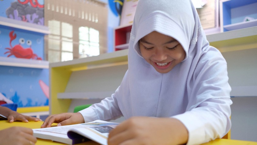 Asian girl reading a book