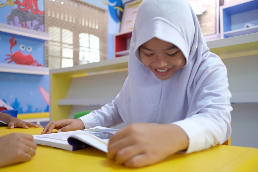 Asian girl reading a book