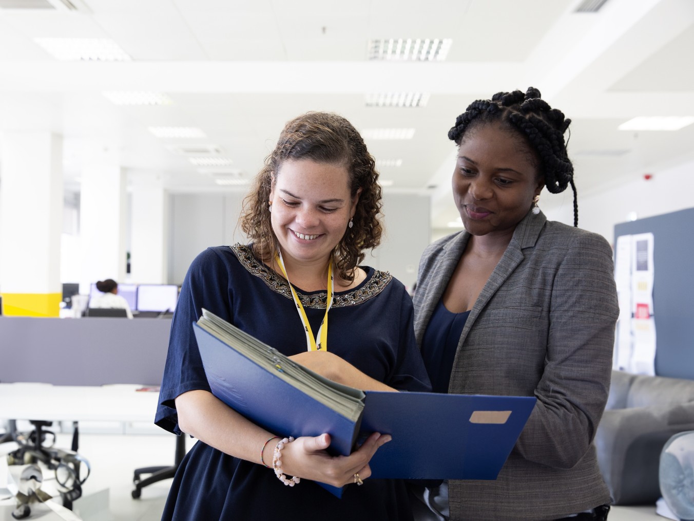 Two Eni employees look at documents in the office