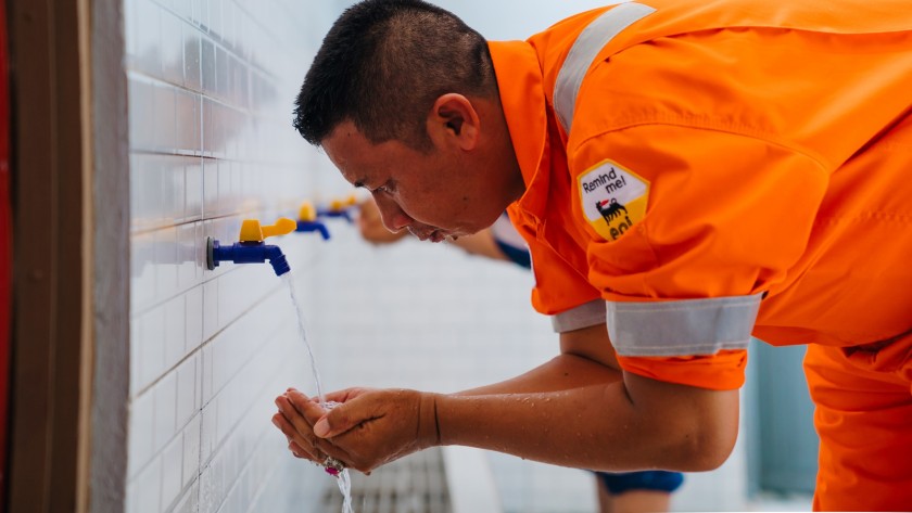 Indonesian man washing his hands with running water