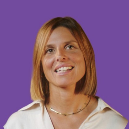 A smiling girl with blond hair and a white dress