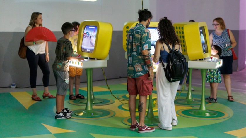 People playing in front of monitors
