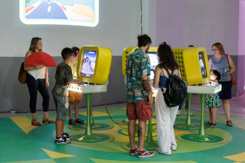 People playing in front of monitors