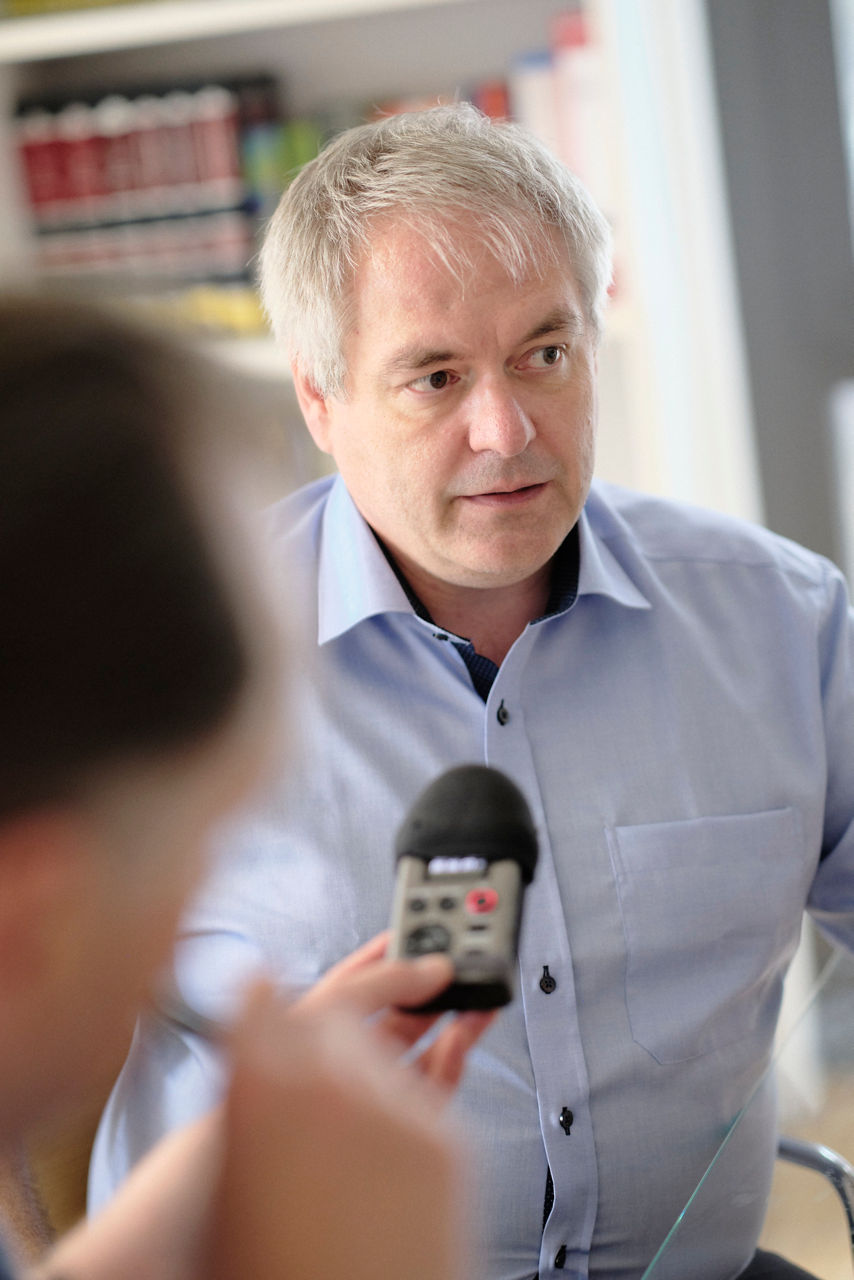 In the interview, Professor Waldvogel speaks into a recording device.