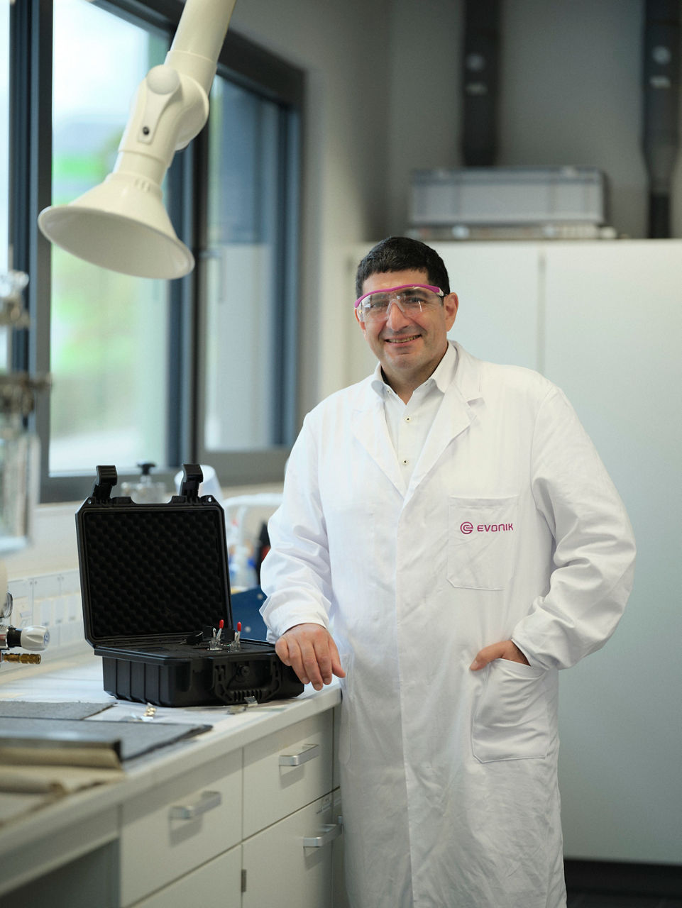 Alexander Azzawi stands at a lab table with the open case.
