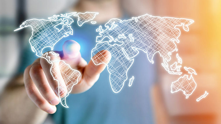A hand pointing at a glowing, sketched world map with a blurred background.