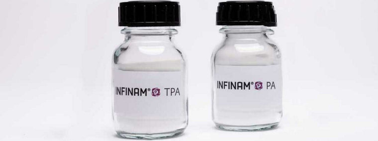 The picture shows two glass vials with white labels. The left vial contains INFINAM® TPA, while the right vial is labeled INFINAM® PA. Both vials have black screw caps and are arranged against a neutral white background.