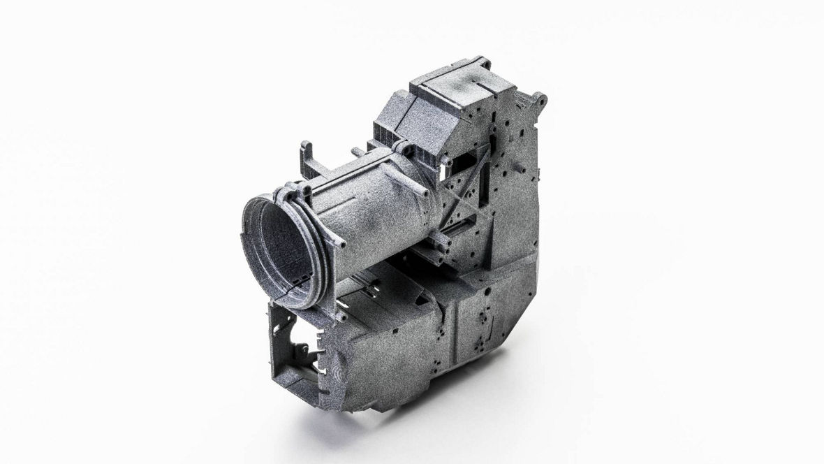 Large, complex 3D-printed mechanical component made from INFINAM® PA12 powder using High Speed Sintering (HSS), designed for industrial use.