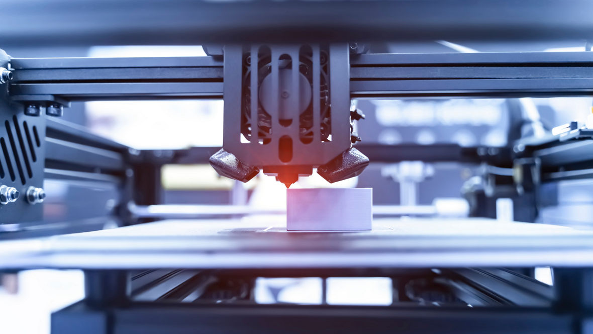 3D printer creating a white polymer part with high accuracy using additive manufacturing technology.