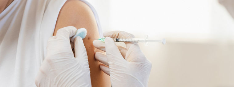 People getting a vaccination to prevent pandemic concept. Mature Woman in medical face mask  receiving a dose of immunization coronavirus vaccine from a nurse at the medical center hospital


Vaccination