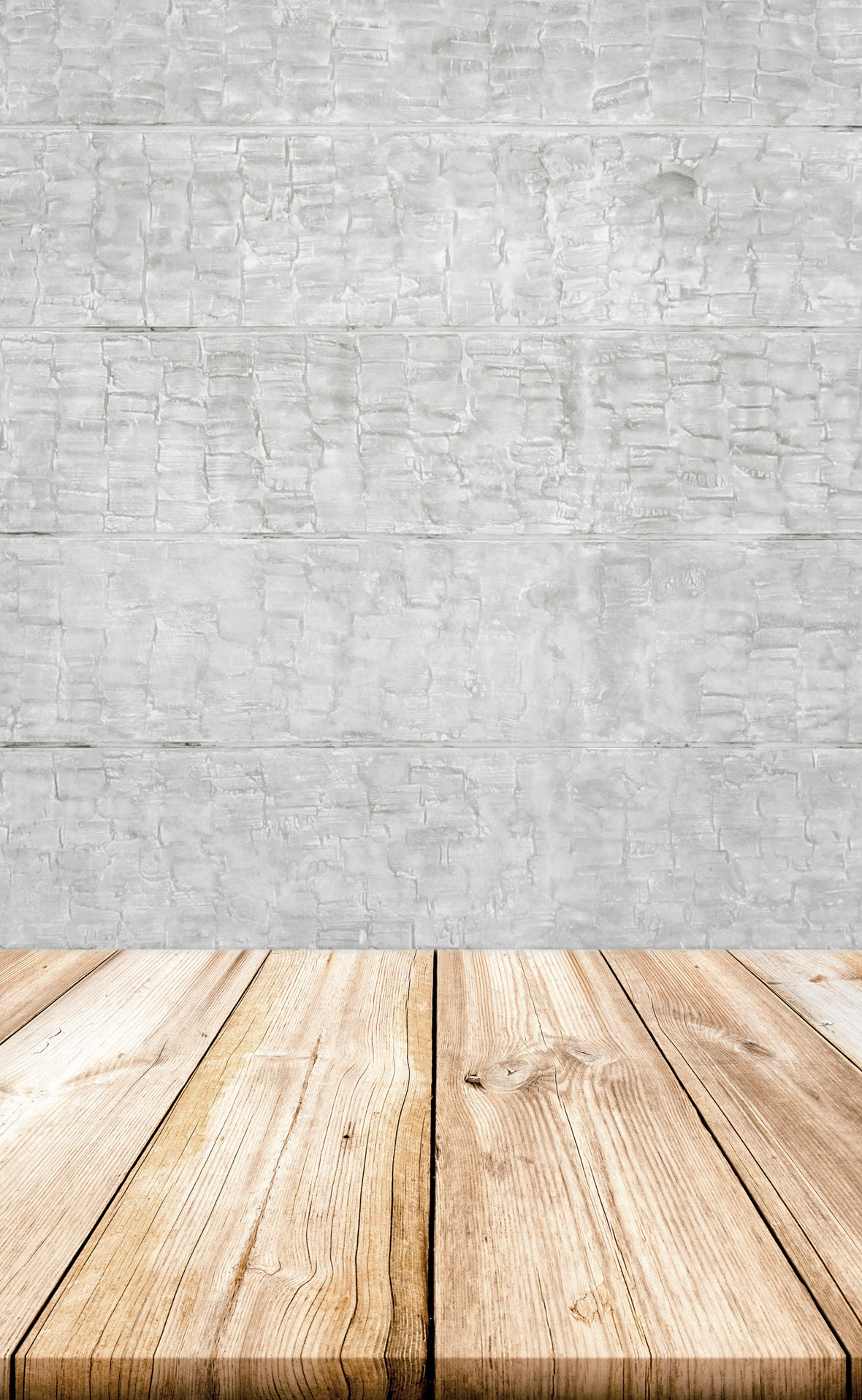 Empty light wood table top with concrete wall background. 