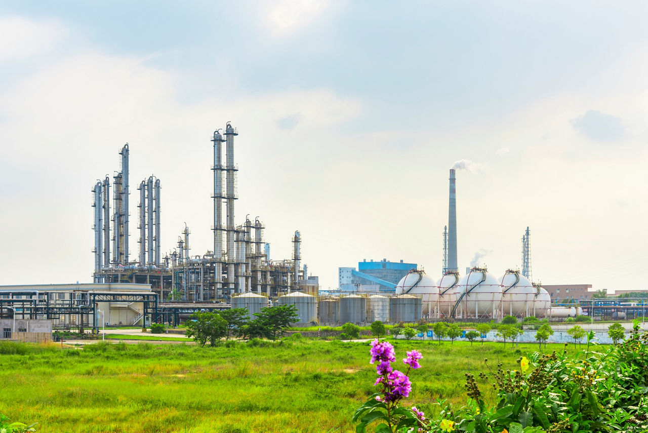 Oil refineries and storage tanks in the plant under the background of blue sky white clouds
