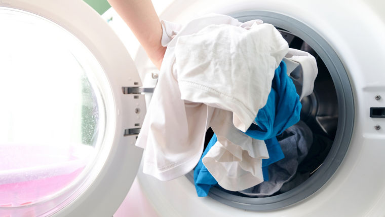 man's hand Pick up clothes Washing machine.Clean and Healthy Concepts