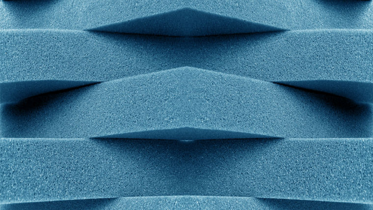 Close-up of blue polyurethane foam with triangular ridges, representing the structural precision enabled by TEGOSTAB® surfactants in high-performance PU applications.