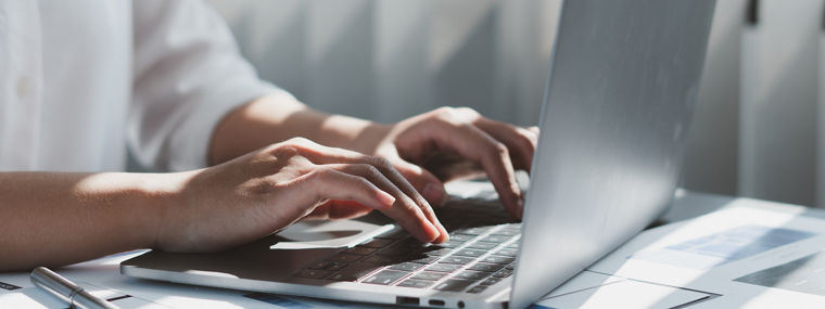 Person working on laptop representing personalized polyurethane support via EXPLORE PU