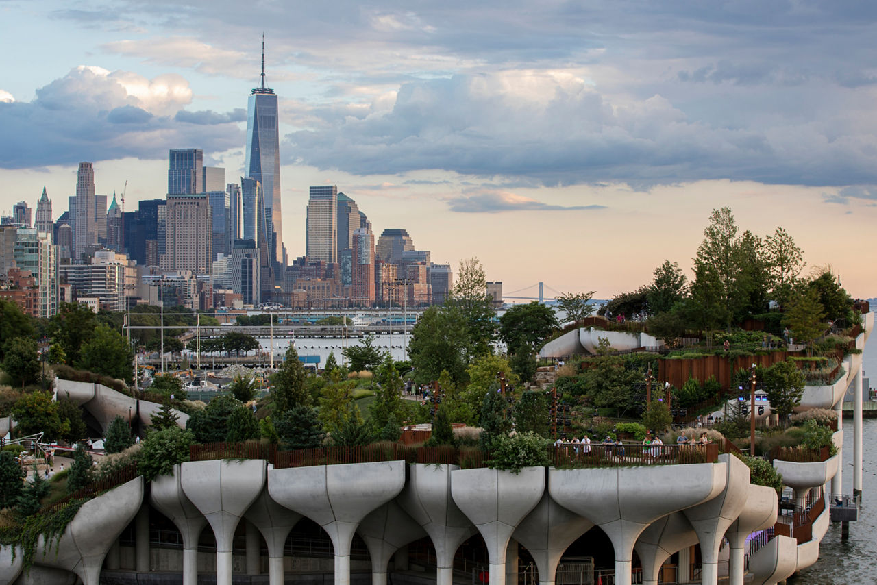 Little Island Park, an artificial island on concrete stilts. Lower Manhattan in the background.
