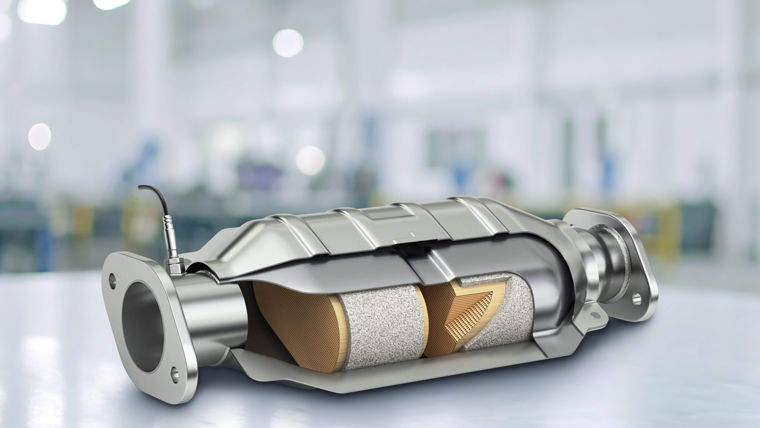 Cutaway view of a catalytic converter showing internal honeycomb structure.