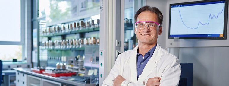 Scientist in a lab analyzing data on animal nutrition to improve health and performance through precise amino acid use.
