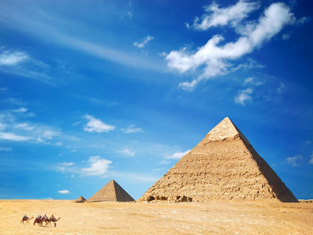 The three Giza pyramids in front of a blue sky