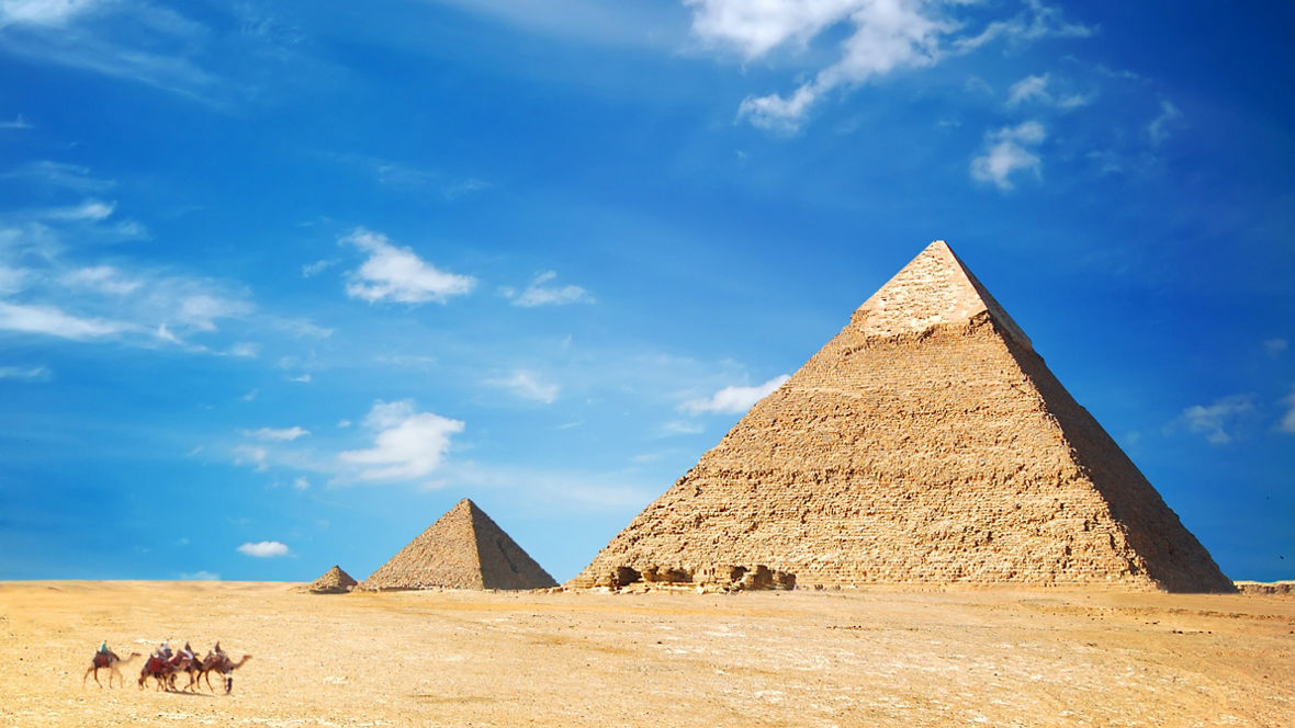 The three Giza pyramids in front of a blue sky