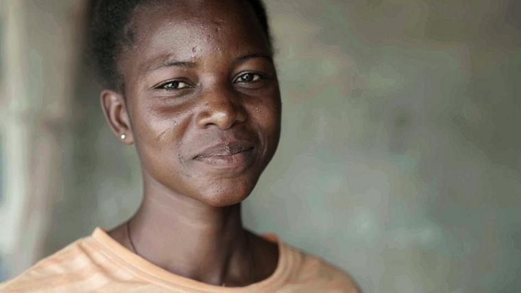 One of the villagers smiles for the cam