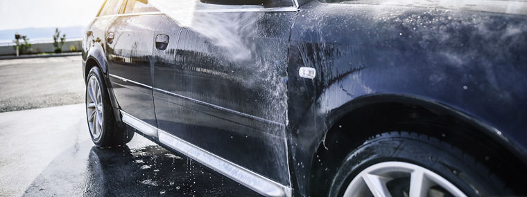 High-pressure washing car outdoors. Car washing under the open sky.