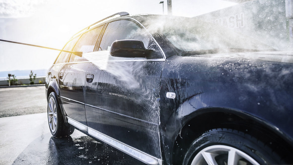 High-pressure washing car outdoors. Car washing under the open sky.