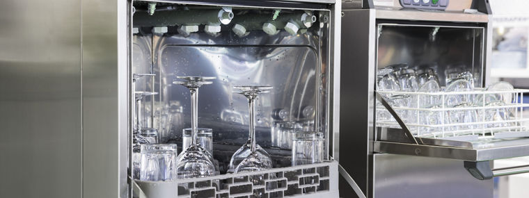 Open dishwasher with clean glass, cups, plates and dishes, selective focus 