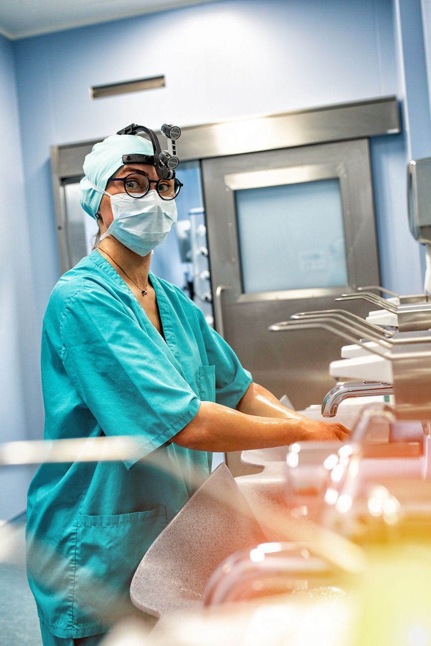 Doctor surgeon preparing for surgery and washes his hands.