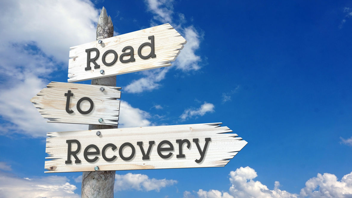 Road to recovery - wooden signpost with three arrows