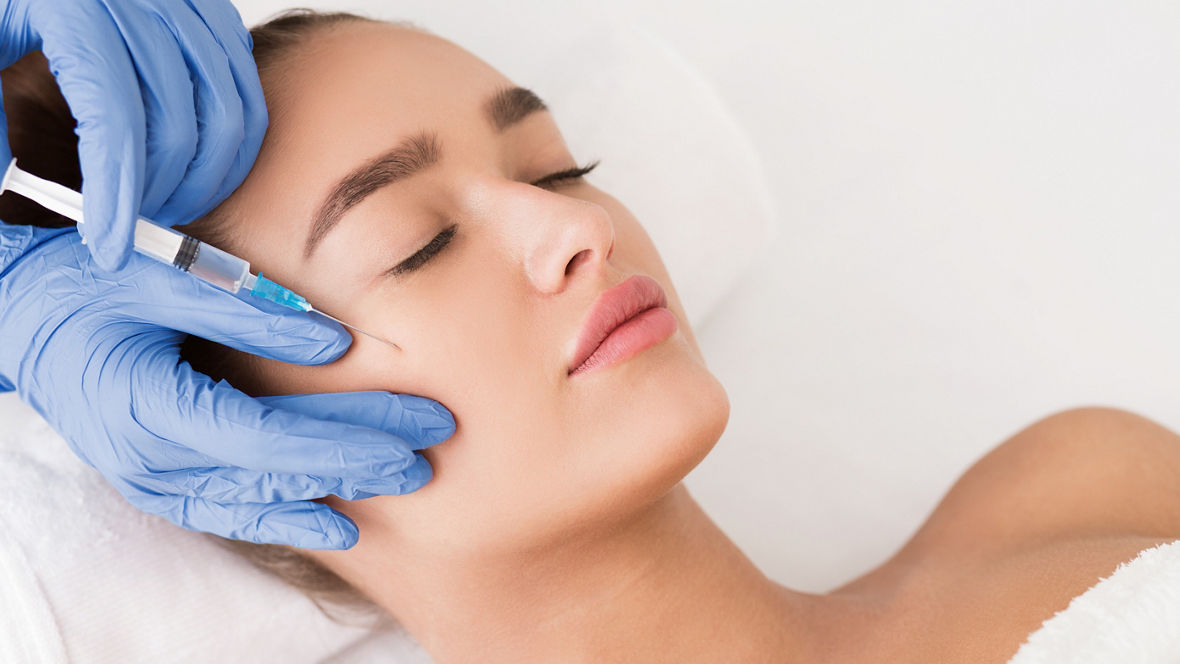 Beauty procedure. Woman receiving hyaluronic acid injection in spa salon