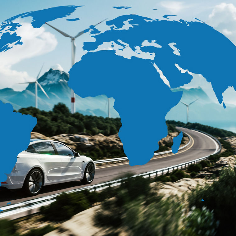 Electric car driving on country road in front of wind turbines, with the continents depicted as blue silhouettes.