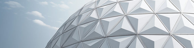 Geodesic dome structure with triangular panels under a partly cloudy sky.