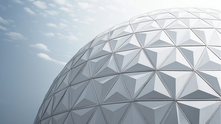 Geodesic dome structure with triangular panels under a partly cloudy sky.