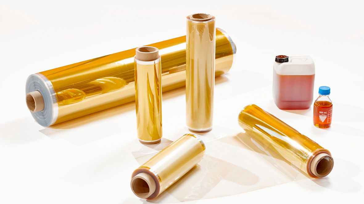 Duraion® AEM membrane rolls by Evonik for electrolysis, shown as transparent amber polymer films used in hydrogen production systems.