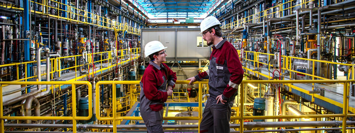 Two Evonik employees in the Digester hall for rhamnolipid production in Slovenská Ľupča, Slovakia