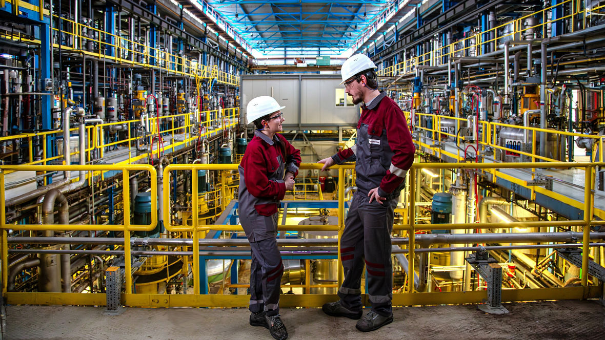 Two Evonik employees in the Digester hall for rhamnolipid production in Slovenská Ľupča, Slovakia