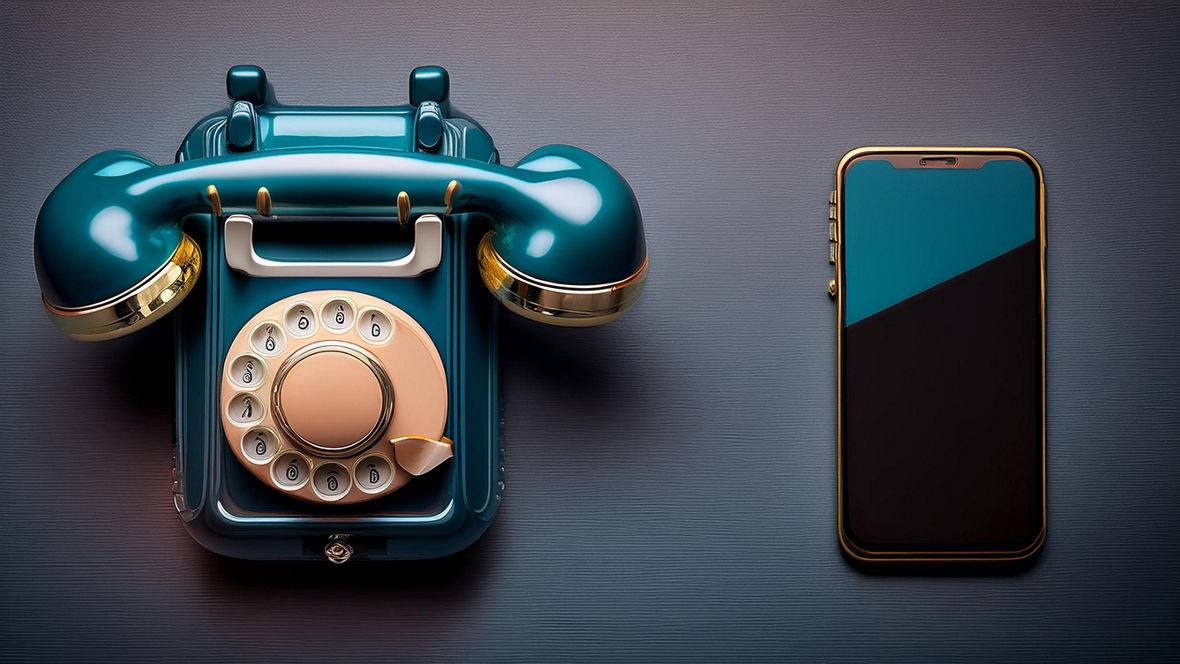 A rotary dial telephone and a smartphone next to each other.