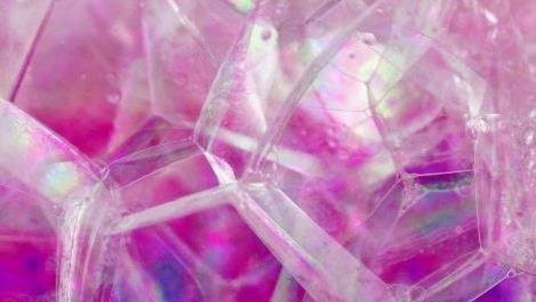 Close-up illustration of iridescent bubbles with a vibrant purple background.