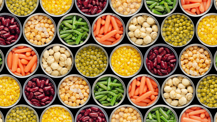 Seamless food background made of opened canned chickpeas, green sprouts, carrots, corn, peas, beans and mushrooms on black background