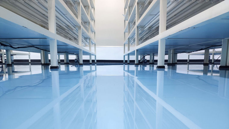 a cable under rack legs at sea blue epoxy floor. (Industrial epoxy floor)